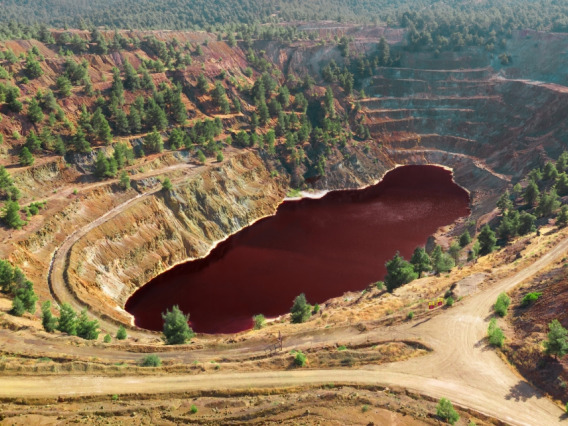 Picture of An acidic red lake that formed in the pit of an abandoned copper mine in Cyprus.